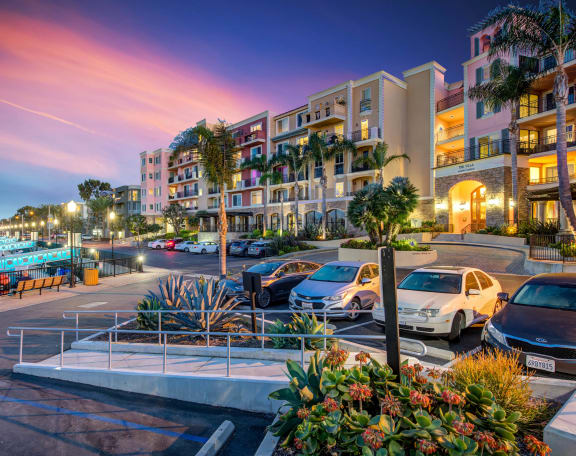 a city at dusk with cars parked in a parking lot at Marina Harbor, California, 90292