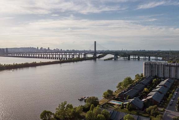 a bridge over a river with a city in the background
