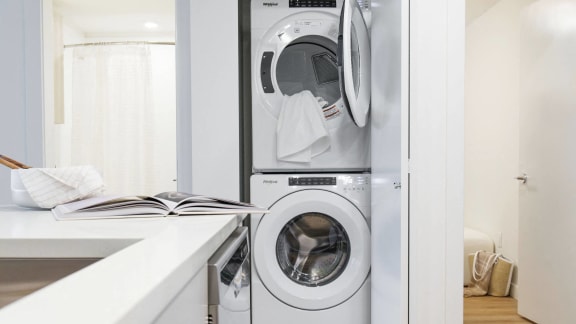 a white laundry room with a washing machine and a dryer