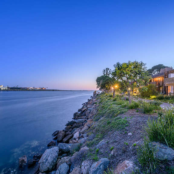a home on the water overlooking the water at night at Mariners Village, Marina del Rey, California