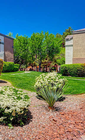 A well-maintained garden in front of a building.