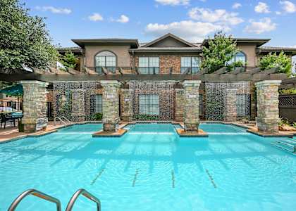a swimming pool with a house in the background