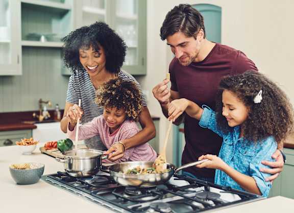 a family is preparing a meal in the kitchen