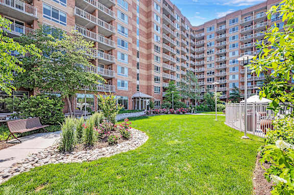 A large grassy area in front of apartment buildings.