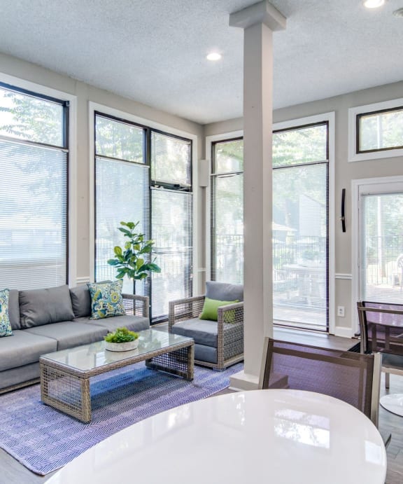 a living room with a couch and a table in front of windows at Glen Hollow, Georgia