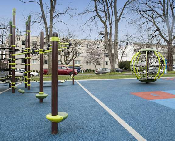 a playground in a park in front of a building