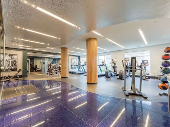 a room filled with cardio equipment and a large painting on the wall at Heights at Glen Mills, PA 19342