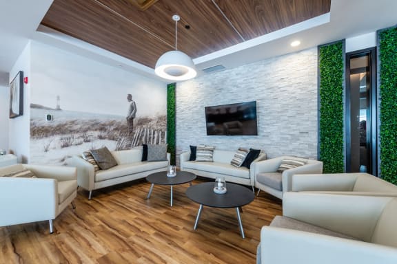 a living room with white couches and a table