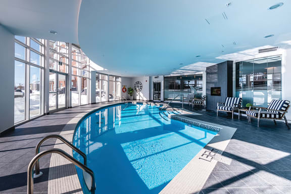 a swimming pool in a hotel with a blue light above it