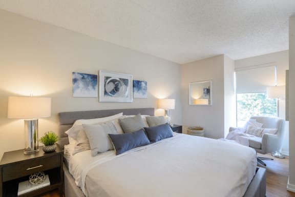 a bedroom with a large bed and a living room with a couch