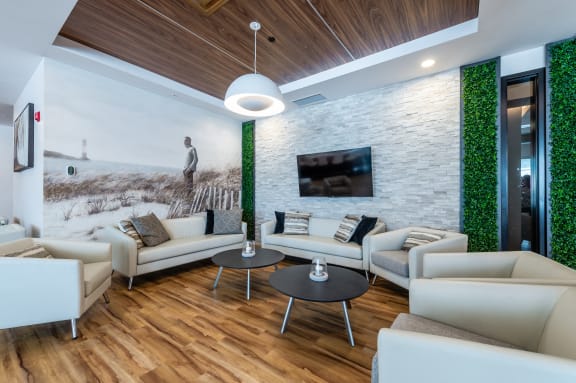 a living room with white couches and a table
