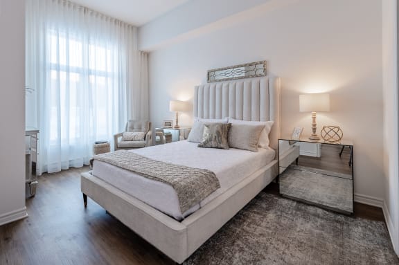 a bedroom with a large bed and a window