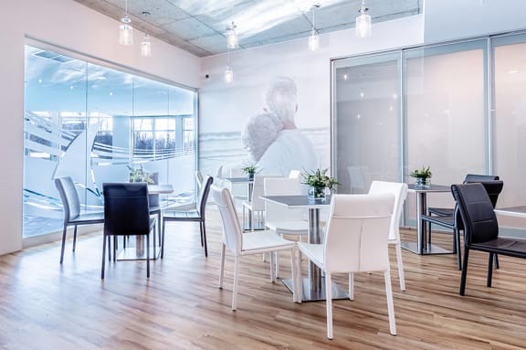 a dining room with a table and chairs and a person in a window