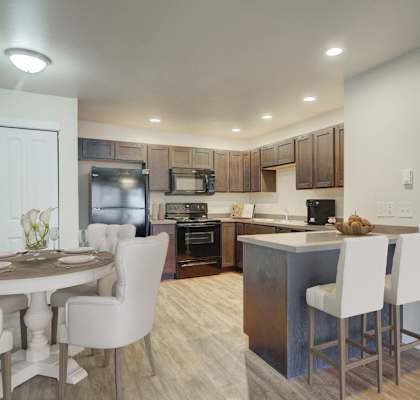a kitchen and dining area with a table and chairs in a home at Madison Park, Bozeman, MT