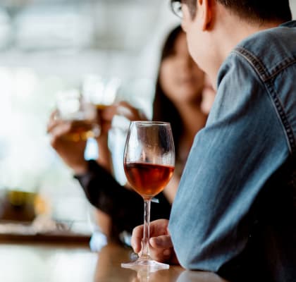 people drinking wine at a bar