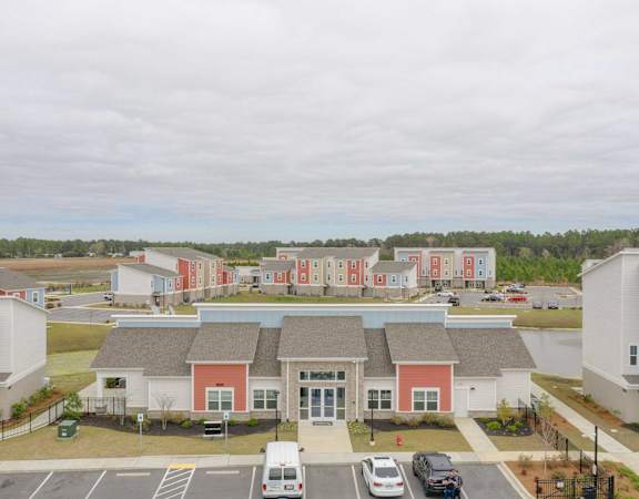 an aerial view of a group of houses in a parking lot