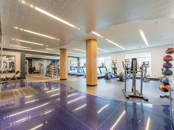 a room filled with cardio equipment and a large painting on the wall at Heights at Glen Mills, PA 19342