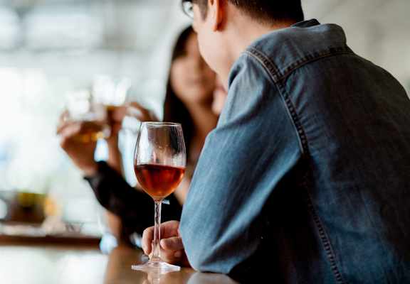 people drinking wine at a bar