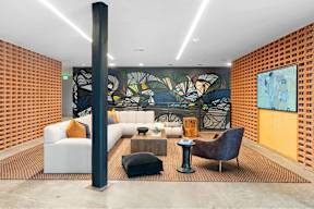 A modern living room with a large mural on the wall.