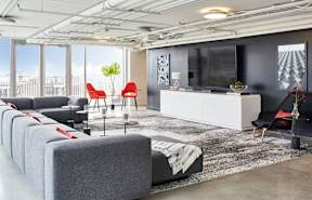 a living room with couches and a rug
