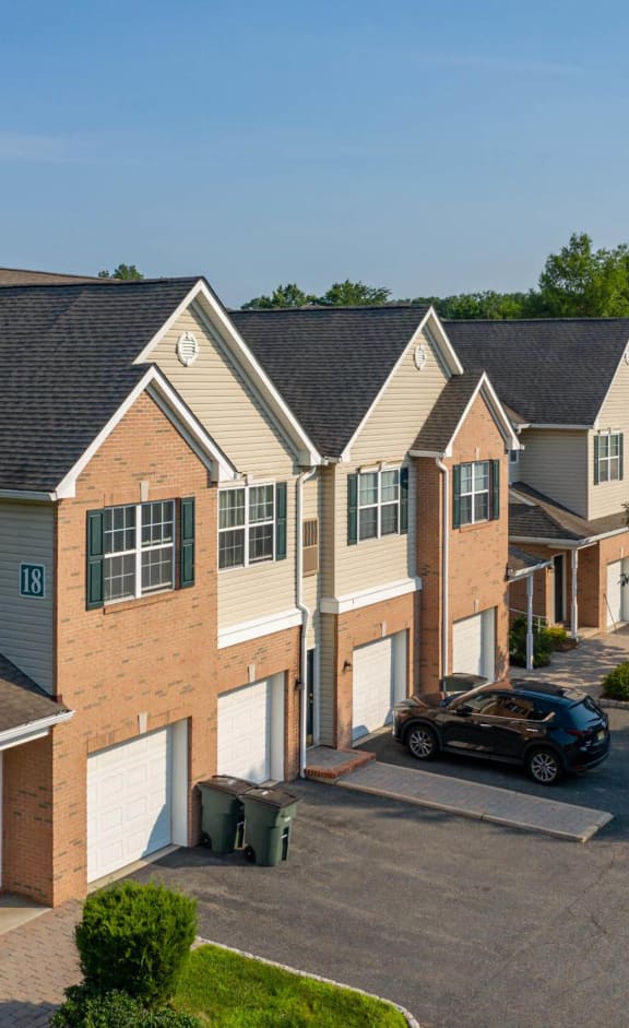 a row of houses with a car parked in a parking lot
