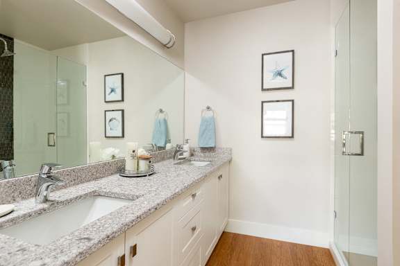 a bathroom with two sinks and a large mirror