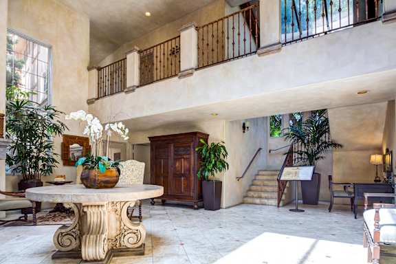 a large living room with a marble table and a staircase