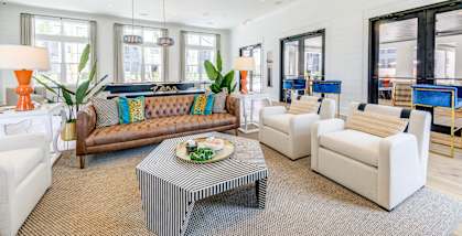 a living room with couches and chairs and a coffee table at Residences at 393 North Apartments, Florida