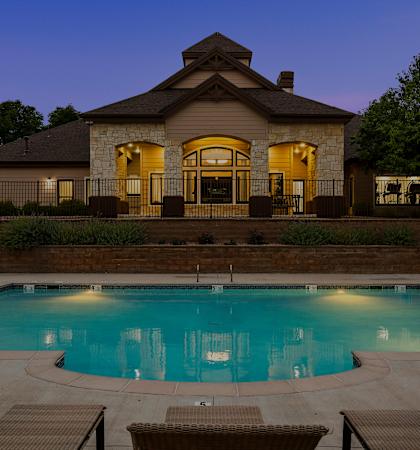 Grand Centennial Apartments - Heated pool and leasing center at dusk