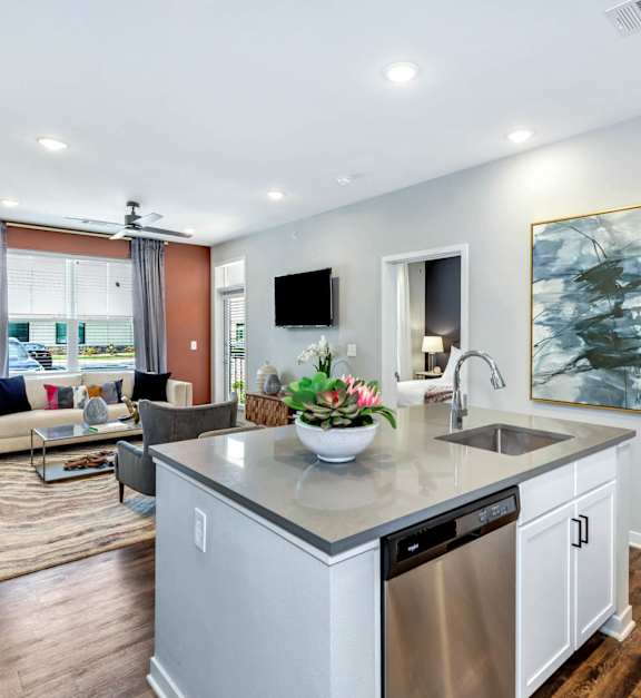 a kitchen with an island and a living room with a couch at Farmhaus Apartments, Alabama, 35757