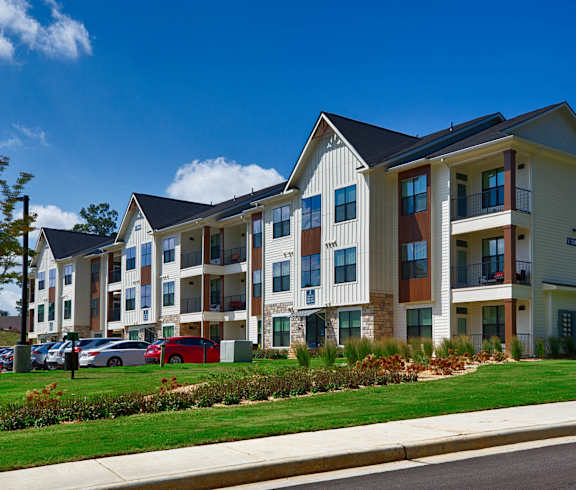 an apartment building on the side of a street at Farmhaus Apartments, Alabama, 35757