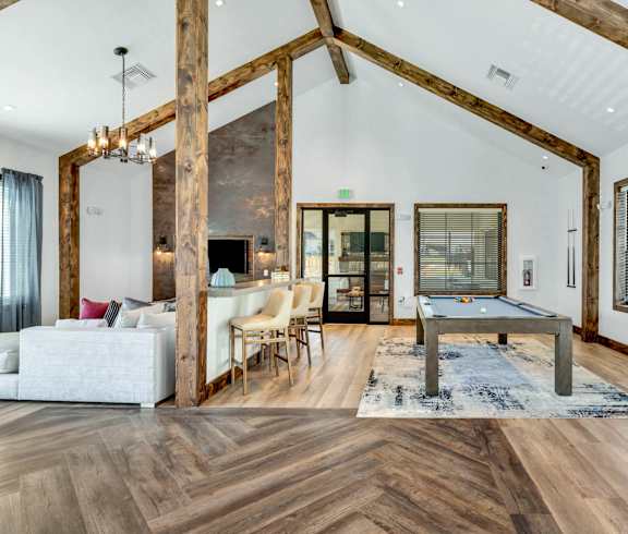 a living room with a pool table in the middle of it at Farmhaus Apartments, Alabama, 35757