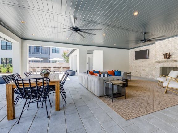 a living room with a couch and a table and a fireplace at Residences at 393 North Apartments, Santa Rosa Beach, Florida