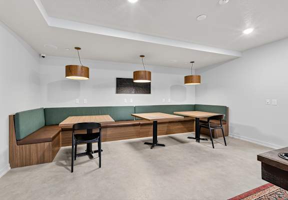 A room with a long table and chairs.