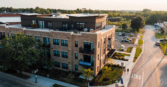 an aerial view of a building in a city street