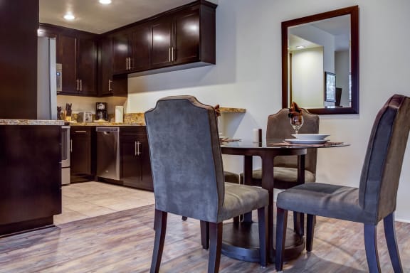a dining room with a table and chairs and a kitchen  at L'Estancia, California, 91604
