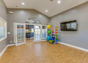 Thumbnail 3 of 8 - A room with wooden floors and a large window.