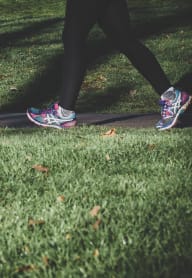 a person walking on a sidewalk in the grass at University Park, California