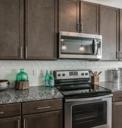 a kitchen with stainless steel appliances and granite counter tops at Village at Westland Cove Apartments, Knoxville, TN, 37922