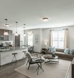 a living room with a kitchen and a couch at Village at Westland Cove Apartments, Tennessee, 37922