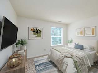 A bedroom with a bed, a nightstand, a lamp, a plant, and a painting on the wall.