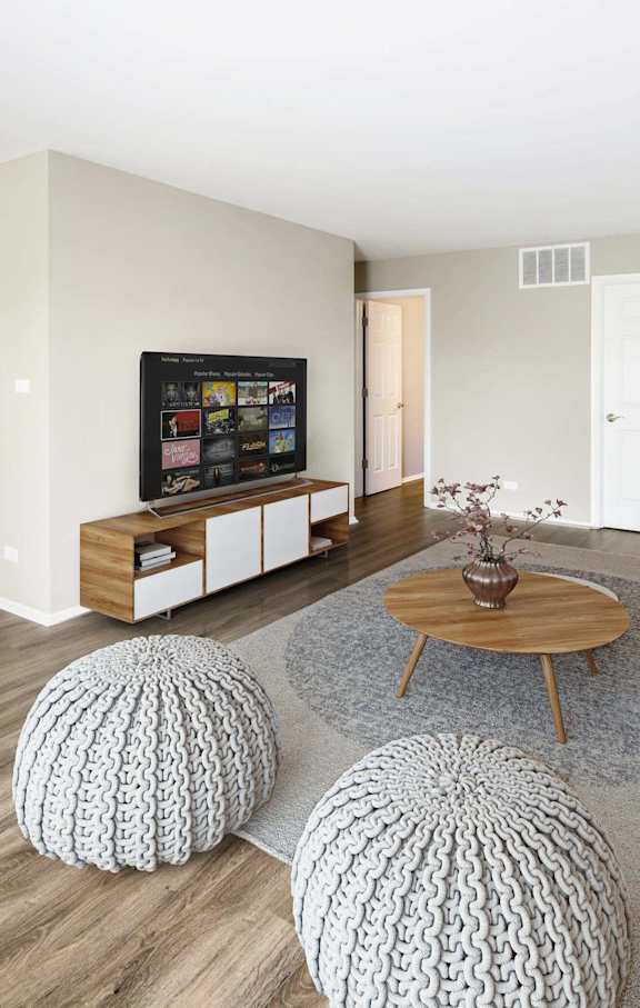 A living room with a white ceiling and a grey couch.