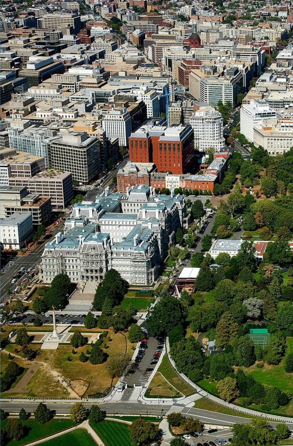 an aerial view of the capitol building and a green park