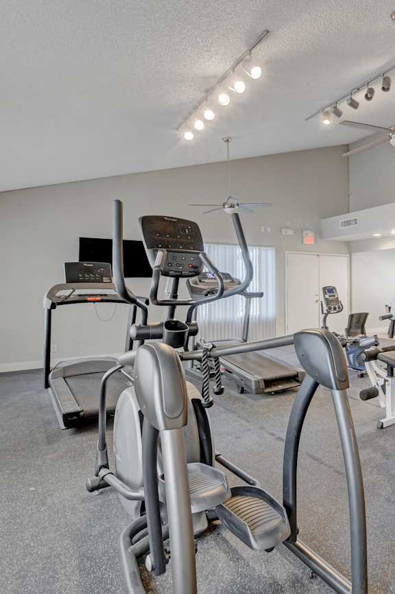 A home gym with a variety of exercise equipment.