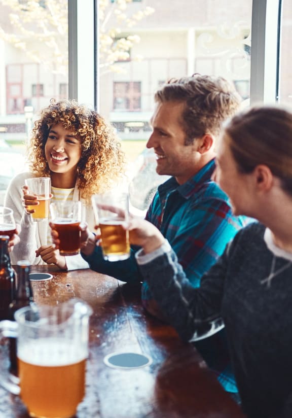 a group of people sitting around a table drinking beerat First Street Lofts in Downtown Bismarck, Bismarck
