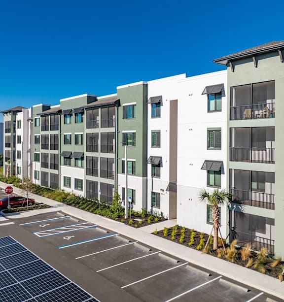 Apartment building with a car parked in front.