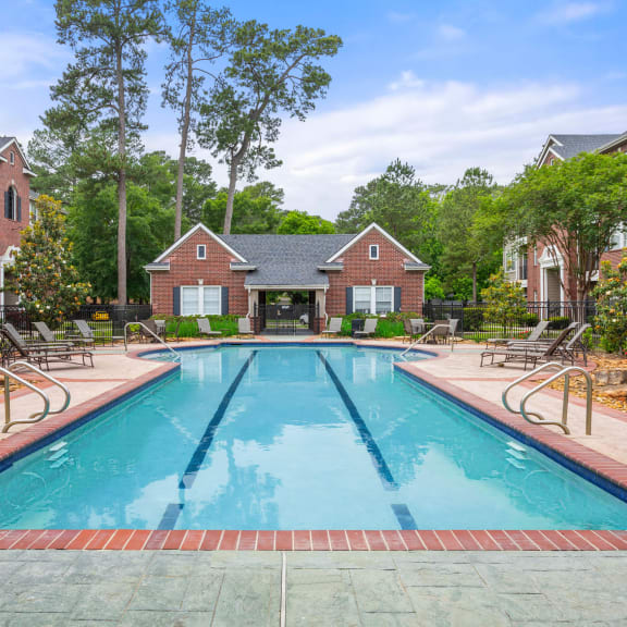 a swimming pool with a house in the background at Villages of Cypress Creek, Houston, Texas