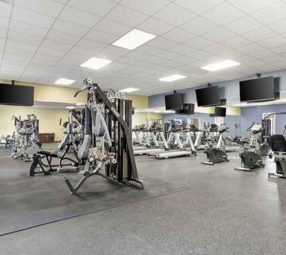 a gym with a variety of weights and cardio equipment at Veranda at Centerfield in Houston, 77070