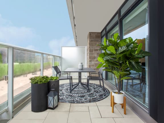 a patio with a table and chairs on a balcony