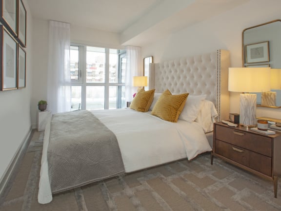 a bedroom with a large bed and a window